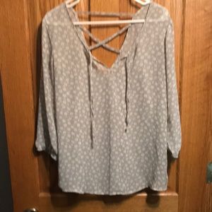 Women’s light blue blouse with white flowers.